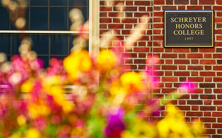 Schreyer Honors College sign with flowers